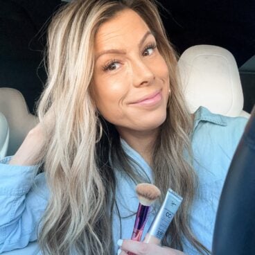 Corrine holding IT Cosmetics CC cream with brush